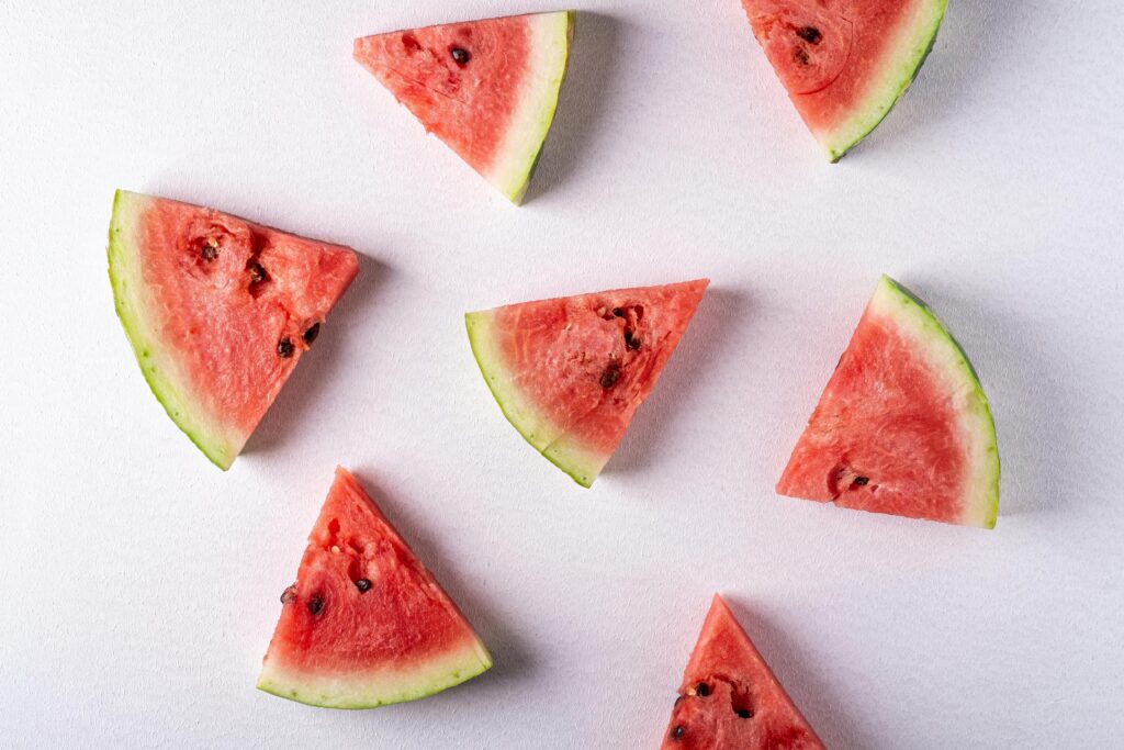 A flat lay image of juicy watermelon slices on a white background, perfect for summer themes.